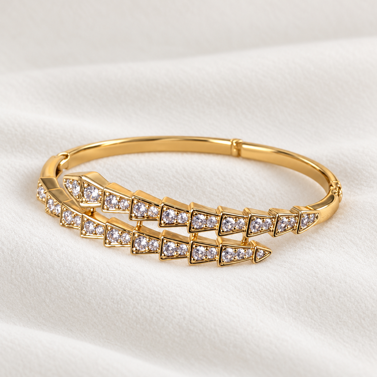 Gold-tone serpent bracelet with clear stone detailing